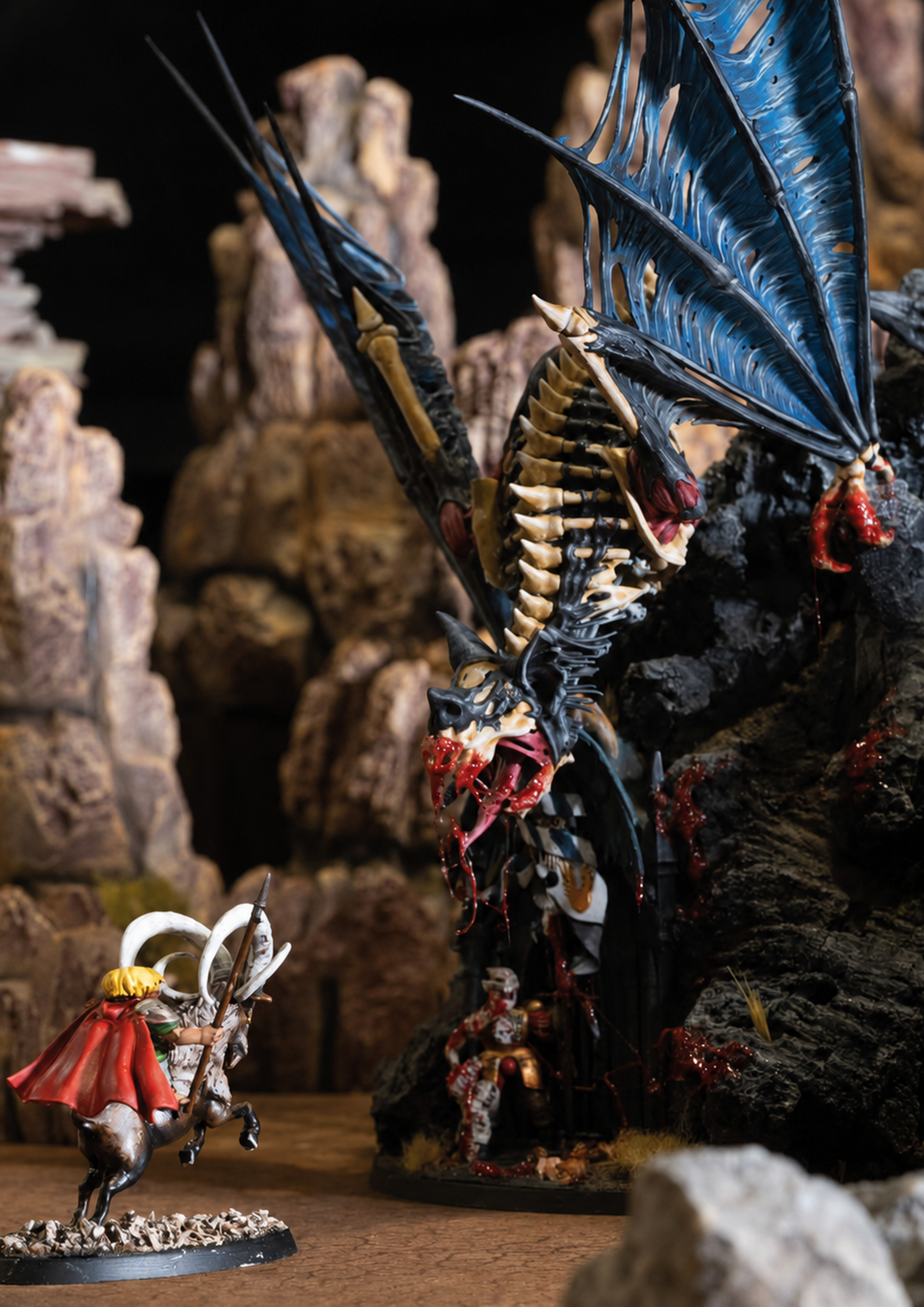 A Gnomad hero on a Crag Ibex charges a Terrorgheist